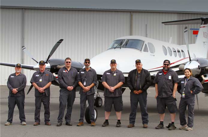 Refurbishment crew with newly refurbished King Air